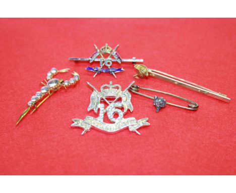 15 carat gold fox's head bar brooch, moonstone scorpion brooch, 16 The Queen's Lancers diamond, ruby and enamel brooch and tw