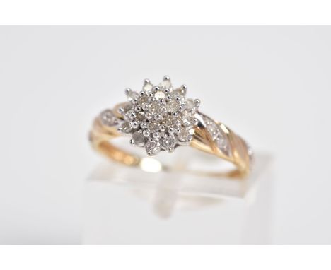 A 9CT GOLD DIAMOND CLUSTER RING, the tiered cluster set with single cut diamonds to the diamond detail shoulders and plain po