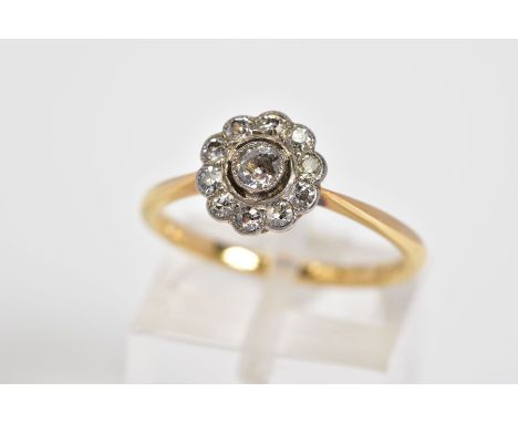 A DIAMOND CLUSTER RING, the yellow metal ring set with a central old cut diamond and a single cut diamond surround, to the ta
