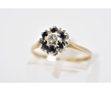 A 9CT GOLD SAPPHIRE AND DIAMOND CLUSTER RING, the raised cluster set with a central single cut diamond, with a circular cut s