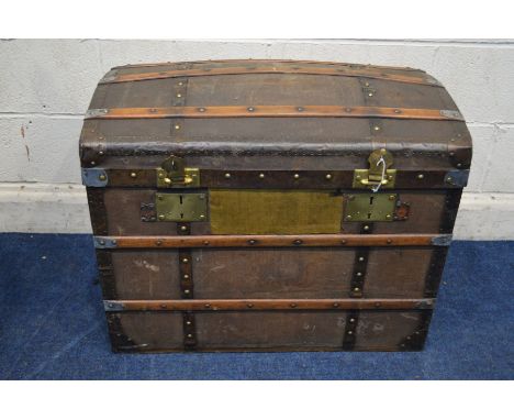 A VINTAGE WOODEN AND METAL BANDED DOMED TOPPED TRUNK, with two internal tray and twin metal drop handles, width 76cm x depth 