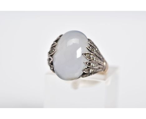 A MOONSTONE CABOCHON RING, the yellow metal ring designed with an oval cut cabochon moonstone, within circular cut colourless