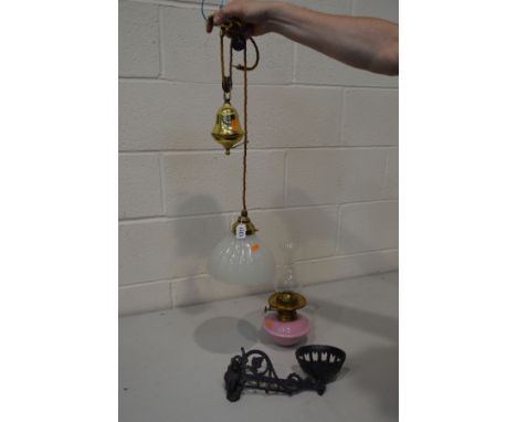 A MID 20TH CENTURY BRASS RISE AND FALL SINGLE LIGHT FITTING, with glass shade, together with a wrought iron wall mounted oil 