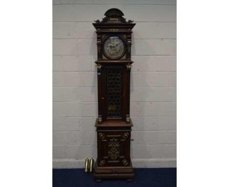 A LATE 19TH CENTURY OAK POLYPHON LONGCASE CLOCK, arched and scrolled pediment above a moulded cornice, the 10' circular silve