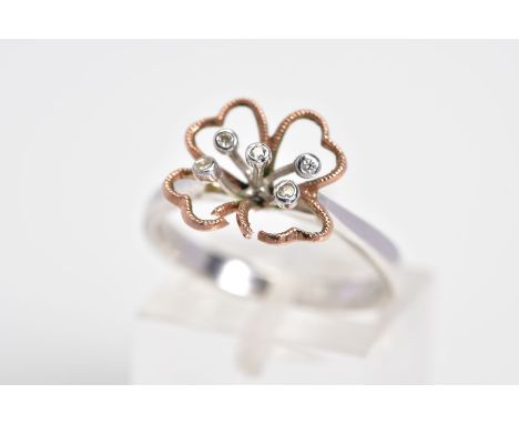 A 9CT WHITE GOLD AND DIAMOND RING, designed with an openwork flower with rose gold leaves, set with five single cut diamonds 