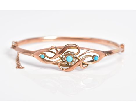 A 9CT ROSE GOLD EDWARDIAN BANGLE, the hinged bangle with an openwork scroll design front, central raised flower set with circ