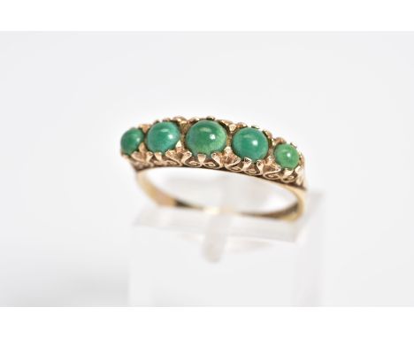 AN EARLY 20TH CENTURY 9CT GOLD RING, set with five graduated circular cut cabochon turquoise, within a scrolling detail galle