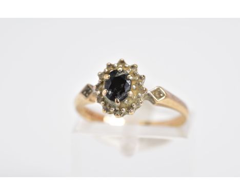 A 9CT GOLD SAPPHIRE AND DIAMOND CLUSTER RING, set with a central oval cut sapphire within a single cut diamond surround, diam