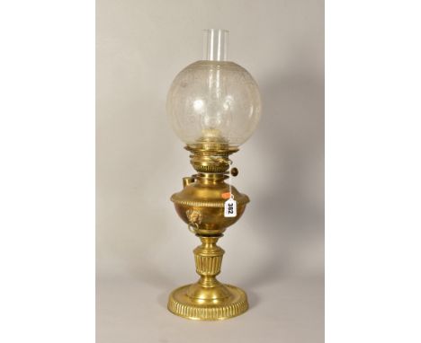 A VICTORIAN BRASS OIL LAMP, with Lion mask ring handles, button marked 'In Lux Way', with glass funnel and glass shade, total