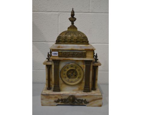 AN EARLY 20TH CENTURY MARBLE AND BRASS FRENCH MANTEL CLOCK, with a Roman figure finial, the brass dial with Arabic numerals, 