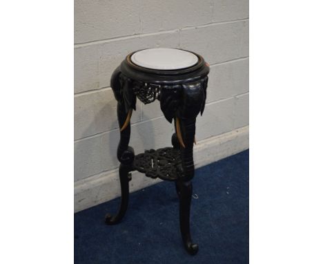 A MID 20TH CENTURY EBONISED CARVED HARDWOOD ORIENTAL JARDINERE STAND with three Elephant head and trunk legs, beech wood tusk