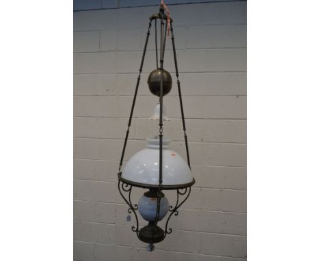 AN EARLY 20TH CENTURY BRASS RISE AND FALL CEILING OIL LAMP, with glass shades and funnel, diameter 48cm x minimum drop 136cm 