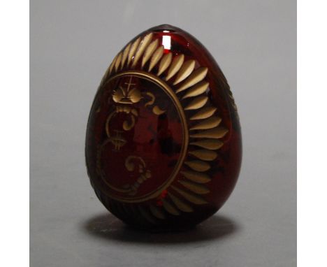 A decorative Russian glass egg ornament, etched with the Russian double-headed eagle, bearing a sticker verso reading Fabergé