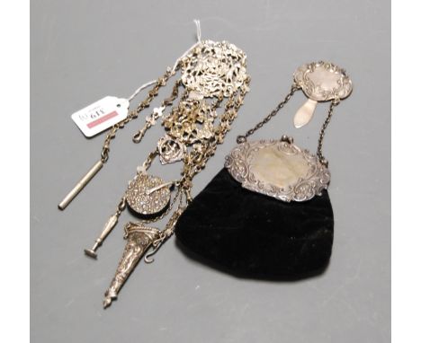 A late Victorian silver chatelaine, having five chains with pin cushion, scissors case, button hook, fob seal and propelling 