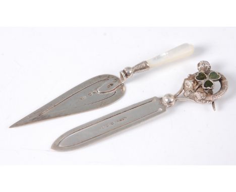 A silver and mother of pearl handled novelty paperclip, in the form of a builders trowel; and another example with hardstone 