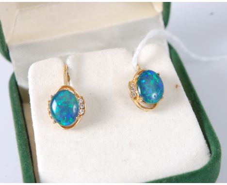 A pair of yellow metal, opal and cz set ear clips, the opal doublets being four claw set, each with spring screw backs, 12mm 