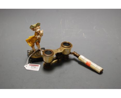 A pair of early 20th century mother of pearl opera glasses together with continental figure of a child holding a lamb (2)