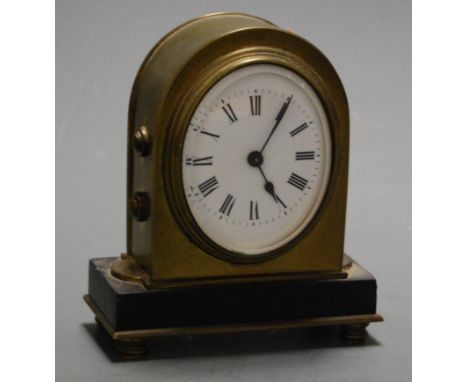 A Victorian lacquered brass cased mantel clock, of lancet form, having an oval enamelled dial with Roman numerals, on a black
