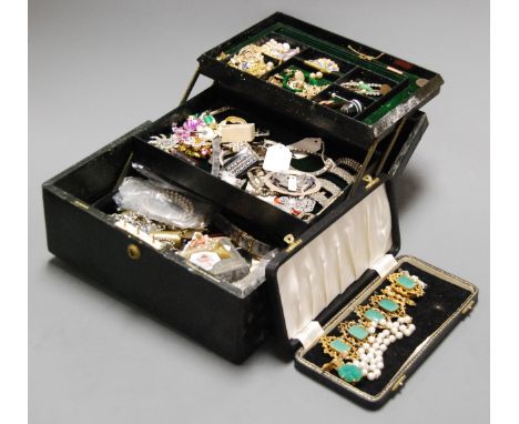 A Victorian leather clad jewellery box and contents to include paste set buckles, enamelled peacock brooch, sterling silver a