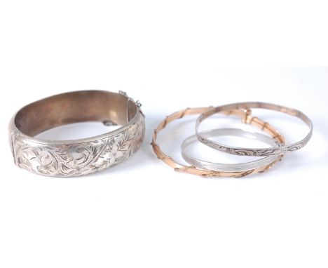 A silver and engraved hinged bangle; together with a rolled gold bangle; and two small silver bangles (4)