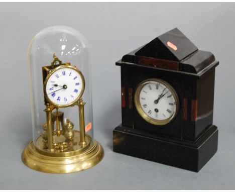 An Edwardian black slate and rouge marble cased mantel clock, having an enamelled dial with Roman numerals, 30 hour movement,
