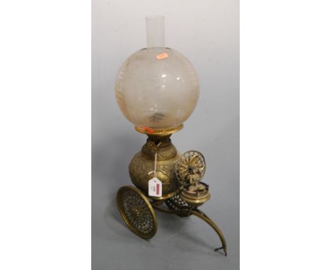 An unusual early 20th century Indian brass oil lamp, having probably associated opalescent glass shade above a globular font,