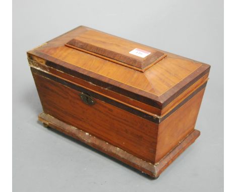 A Victorian satinwood and rosewood crossbanded tea caddy, of sarcophagus form, the hinged lid revealing three compartment int