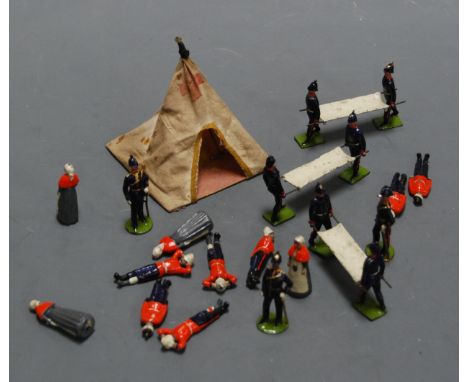 A collection of Britains Royal Army Medical Service military figures to include nurses, stretcher bearers, patients etc, all 