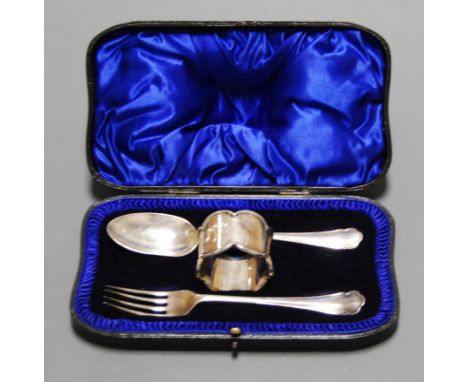 An early 20th century silver three-piece christening set, comprising fork, spoon and napkin ring, in fitted gilt tooled leath