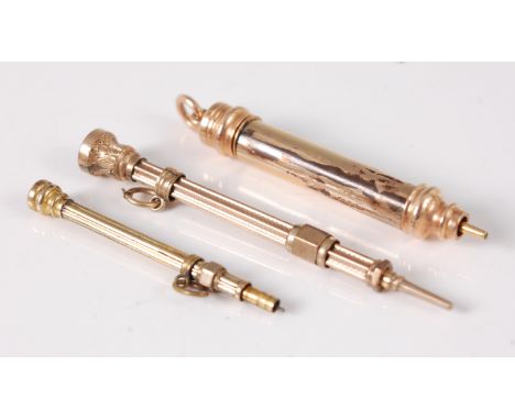 A Victorian yellow metal and amethyst tipped small propelling pencil; one other citrine topped example; and a plain example (