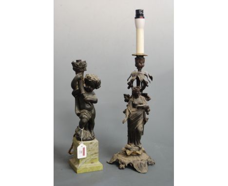 An early 20th century bronzed figural lamp base in the form of a cherub holding a cornucopia on marble base, height 36cm, tog