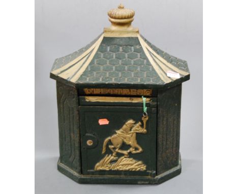 A green painted cast iron letterbox, the door relief decorated with a figure on horseback, height 44cm