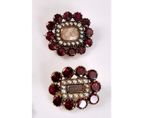 Two mid 19th century garnet and seed pearl mourning brooches, the first with a rectangular glazed panel with blonde hairwork,