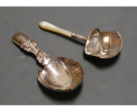 A 19th century silver caddy spoon, having a shield shaped bowl with engraved decoration and shell cast terminal; together wit