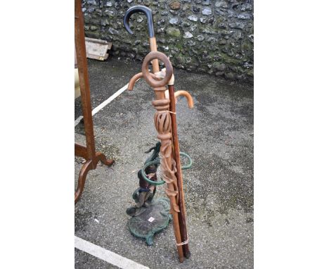 A cast iron stick stand; together with a quantity of sticks.Collection of this lot is strictly by appointment on Saturday 13t