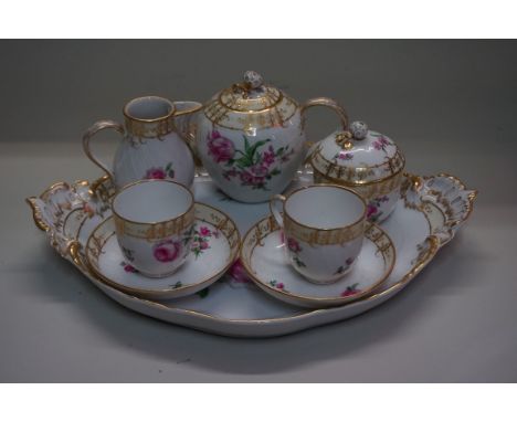 A good KPM Berlin porcelain cabaret service,&nbsp;painted with various pink flowers, comprising: a twin handled tray, 41.5cm 