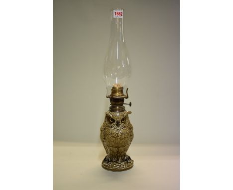 A novelty porcelain owl oil lamp,&nbsp;by William Whiteley, with inset glass eyes, height excluding chimney 25cm, (s.d). 