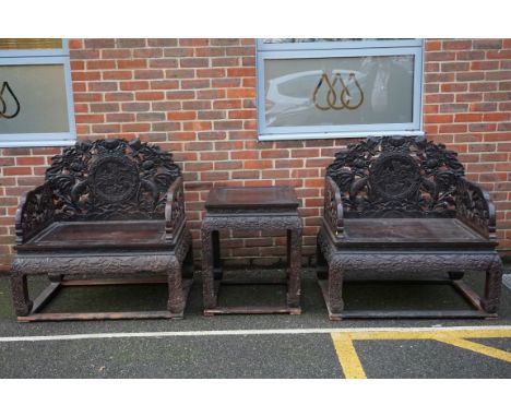 A large pair of Chinese carved and pierced hardwood Imperial throne chairs and matching table,&nbsp;probably early 20th centu