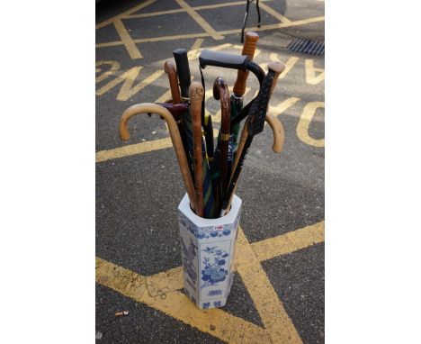 A collection of sticks and canes, to include a Japanese carved bamboo example, together with a blue and white stick stand.&nb