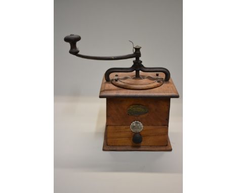A vintage French walnut coffee grinder, bearing brass label inscribed 'Managere...', 16.5cm wide. 