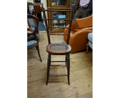 A 19th century fruitwood bobbin and ring turned child's correction chair,&nbsp;with cane seat.&nbsp; 