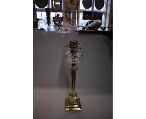A Victorian brass column oil lamp, height excluding chimney 65cm.&nbsp; 