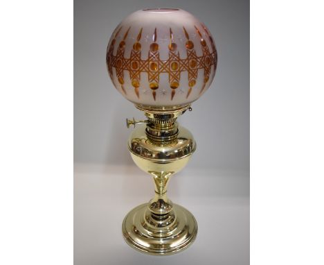 A Victorian brass oil lamp,&nbsp;with amber flashed shade, total height 49cm.&nbsp;&nbsp; 