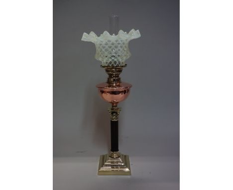 A brass oil lamp, with Corinthian column, copper reservoir, and vaseline glass shade, height including shade 39.5cm. 