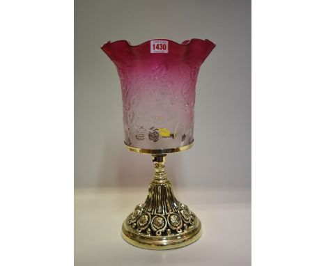 A brass table lamp,&nbsp;with cranberry glass shade, total height 40.5cm. 