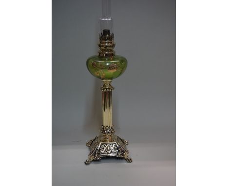 A pierced brass oil lamp,&nbsp;with green glass reservoir, height excluding chimney 41cm. 