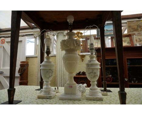 An alabaster table lamp, height excluding fitting 48cm; together with another smaller pair of table lamps, height excluding f