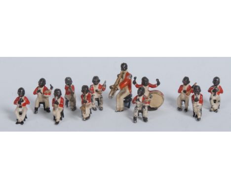 A set of twelve early 20th century cold painted novelty figures, cast as a black jazz band, each member smartly dressed in a 