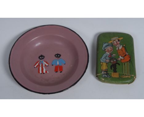 An early 20th century Continental enamel circular child's dish, painted with a black boy and girl on a puce ground, 16.5cm di