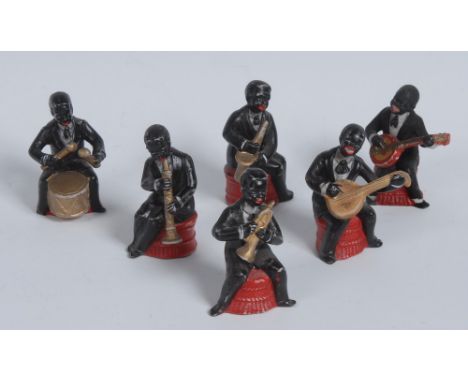 A set of six early to mid 20th century slip-cast models, of Jazz musicians, each smiling and playing his instrument, the tall